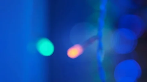 Colored sparklers hang in front of window decorating room Stock Footage 125172054