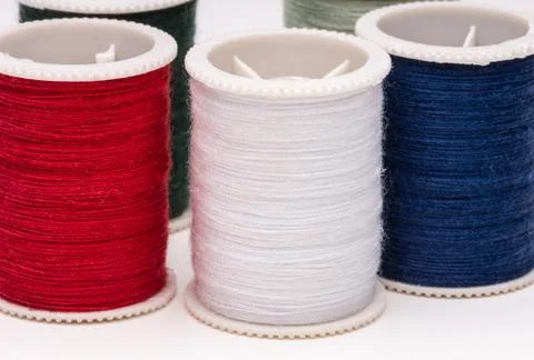 Colored spools of string on white background. Stock Photos