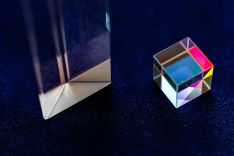 Colored square crystal with a rainbow on a substrate in close-up Stock Photos