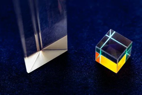 Colored square crystal with a rainbow on a substrate in close-up Stock Photos