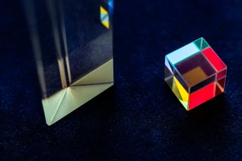 Colored square crystal with a rainbow on a substrate in close-up Stock Photos