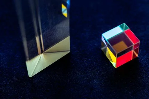 Colored square crystal with a rainbow on a substrate in close-up Stock Photos