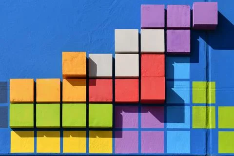 Colored squares on a blue wall Foto stock