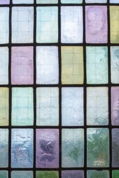 Colored stained glass window with regular block pattern blue green tone Foto stock