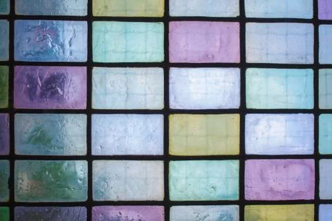 Colored stained glass window with regular block pattern blue green tone 스톡 사진