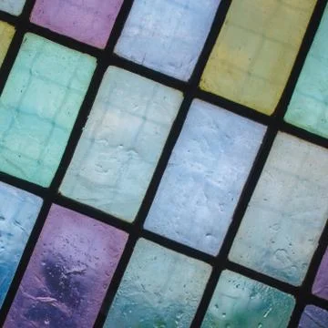 Colored stained glass window with regular block pattern blue green tone Stock Photos