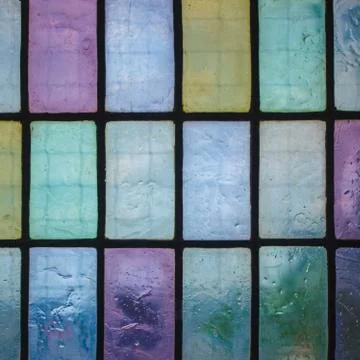 Colored stained glass window with regular block pattern blue green tone Stock Photos
