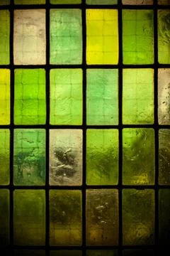 Colored stained glass window with regular block pattern green tone Foto stock