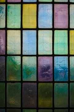 Colored stained glass window with regular block pattern blue green tone Foto stock
