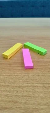 Colored sticky notes on a wooden table. Selective focus. Stock Photos