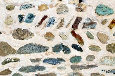 Colored stones embedded in a wall Stock Photos