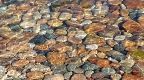 The colored stones in the water Stock Footage 61348401
