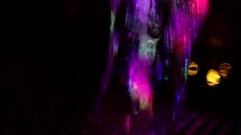 Colored stream of water on dark background. Stock Footage 167919458