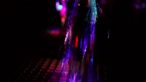 Colored stream of water on dark background. Fountain at night. Stock Footage 167919492