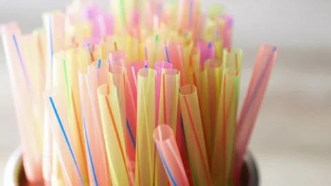 Colored striped bright plastic straws in a jar Stock Footage 217503104