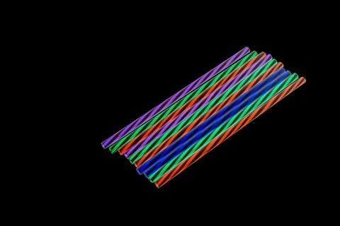 Colored striped plastic drinking straws, white background Stock Photos
