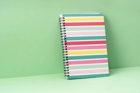 Colored stripes notepad on green. Back to School Stock Photos