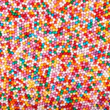 Colored sugar pellets background Foto stock