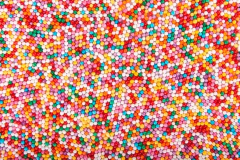 Colored sugar pellets background Stock Photos
