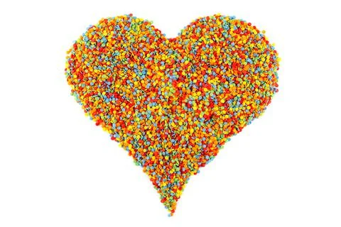 Colored sugar sprinkle dots laid in heart shape isolated on white Фото