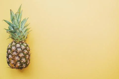 Colored surface with pineapple Stock Photos