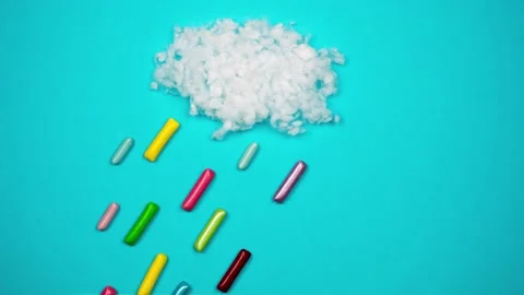 Colored sweets fall like raindrops from cloud. Stop motion Video stock 168644958