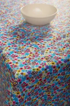 Colored tablecloth and cups on the table. Stock Photos