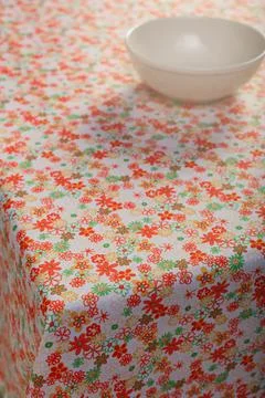 Colored tablecloth and cups on the table. Stock Photos