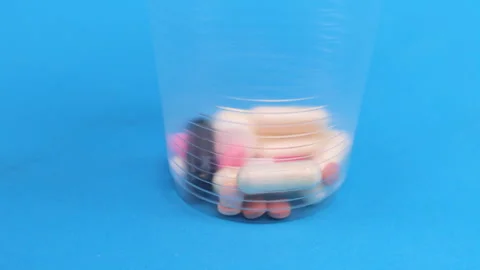 Colored tablets and pills falling down  Stock Footage 276508420