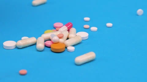 Colored tablets and pills falling down  Stock Footage 276508644