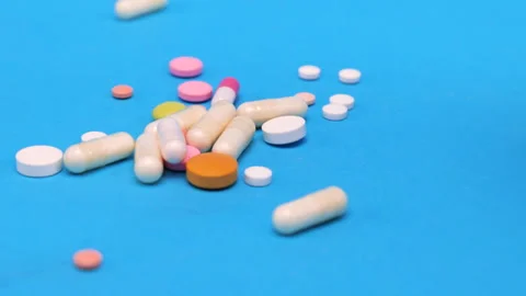 Colored tablets and pills falling down  Stock Footage 276519947
