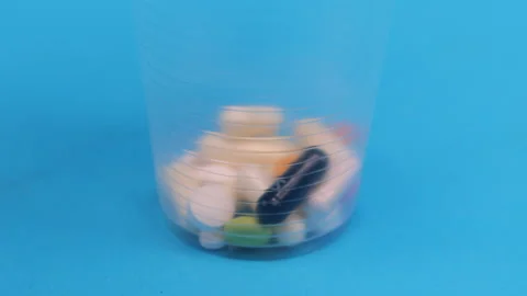 Colored tablets and pills falling down  Stock Footage 276520231