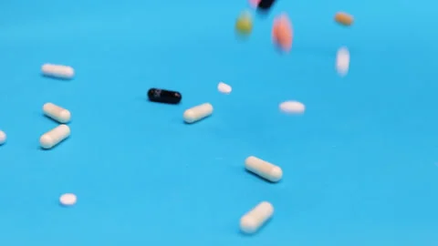 Colored tablets and pills falling down  Stock Footage 276533107