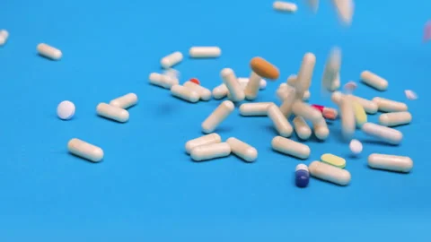 Colored tablets and pills falling down  Stock Footage 276539543