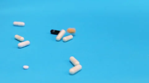 Colored tablets and pills falling down  Stock Footage 276540602