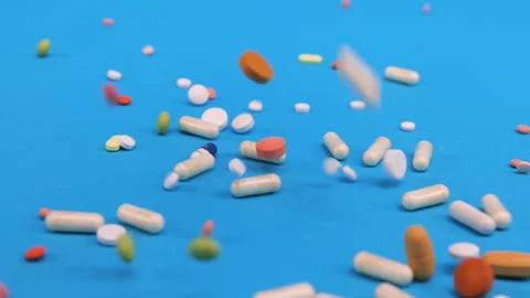 Colored tablets and pills falling down  Stock Footage 276541018