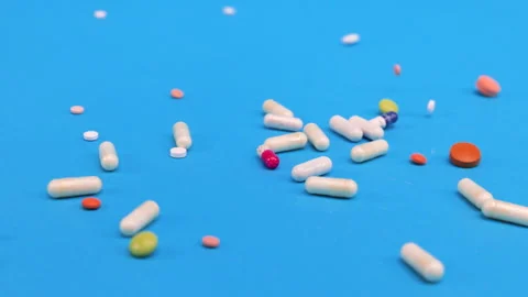 Colored tablets and pills falling down  Stock Footage 276541459