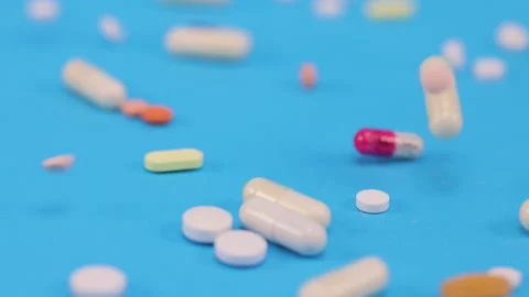 Colored tablets and pills falling down  Stock Footage 276543284