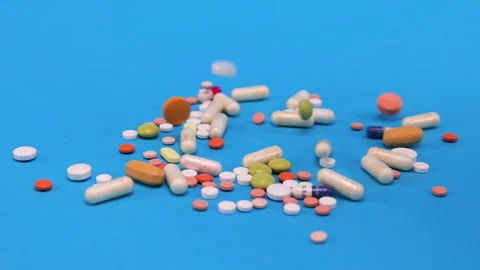 Colored tablets and pills falling down  Stock Footage 276544112