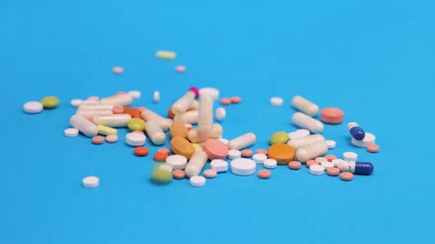 Colored tablets and pills falling down  Stock Footage 276547530