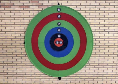 Colored target on a yellow brick wall Stock Photos
