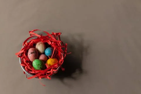 Colored testicles in a red nest Stock Photos