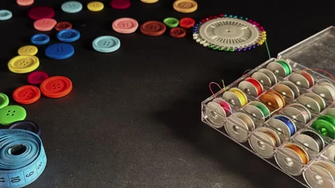Colored Thin Spools of Thread Needles Colorful Buttons and Scissors and Mea.. Stock Footage 306725959