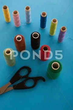 Colored thread and scissors on top Stock Photos