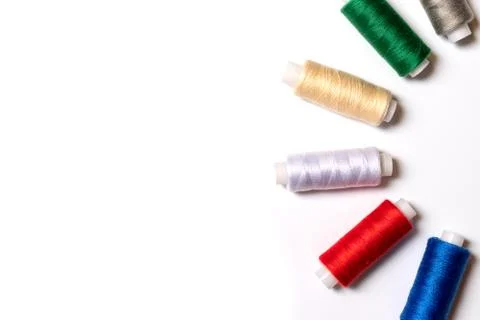 Colored thread coils on white background, sewing, handmade and DIY concept -  Stock Photos