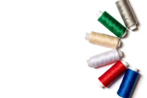 Colored thread coils on white background, sewing, handmade and DIY concept -  Stock Photos
