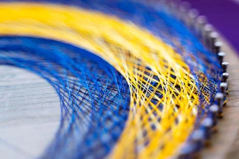 Colored thread mandala on a wooden board with nails. Mandala Moon Harmony Sun Stock Photos