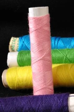 Colored thread on material Stock Photos