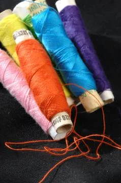 Colored thread on material Stock Photos