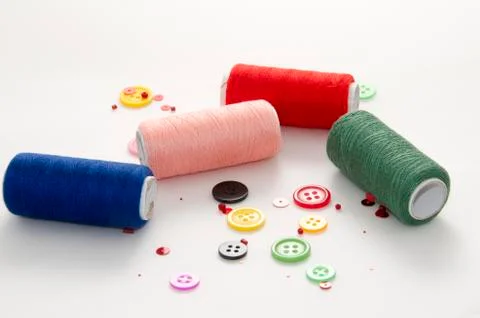 Colored Threads and Buttons on White Background Stock Photos